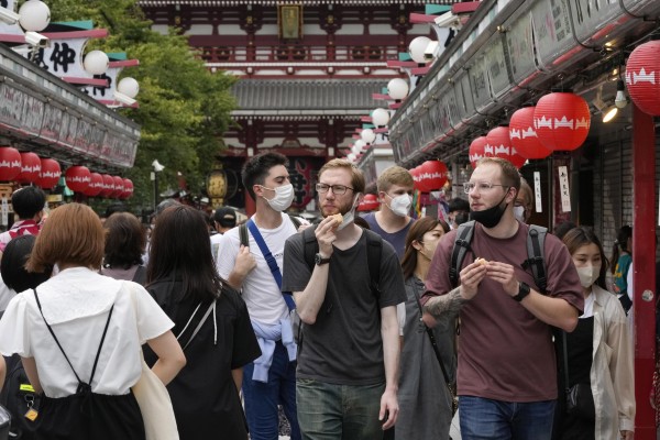 Foreign tourists walk through a street in Asakusa, downtown Tokyo, last week. Photo: EPA-EFE