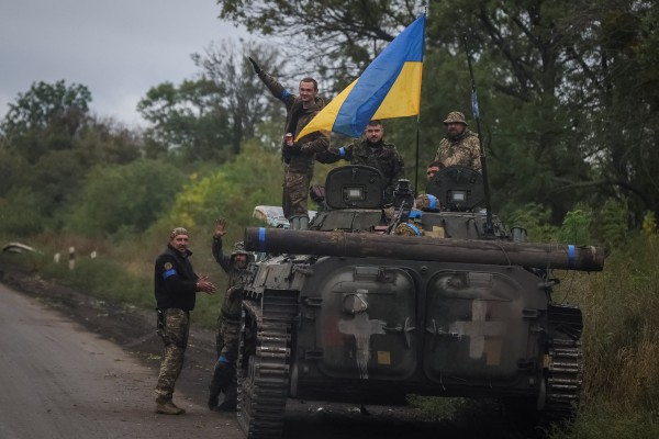 Ukrainian service members on Wednesday stand on an infantry fighting vehicle near the town of Izium, recently liberated from Russian forces. Photo: Reuters
