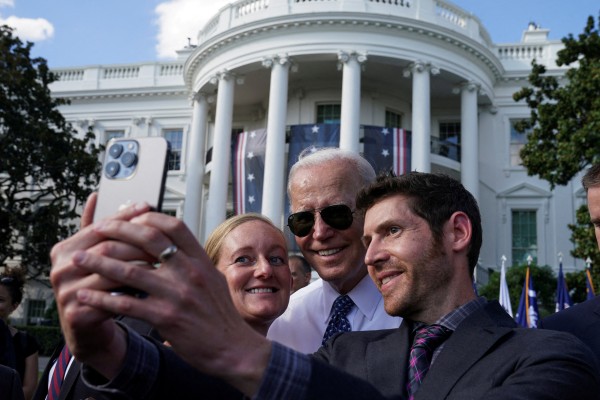 US President Joe Biden posing for a selfie with guests at the White House on September 13. Photo: Reuters
