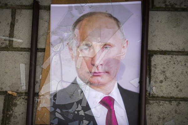 A portrait of Russian President Vladimir Putin lies on the ground near a prison in Kherson, Ukraine. Photo: AP