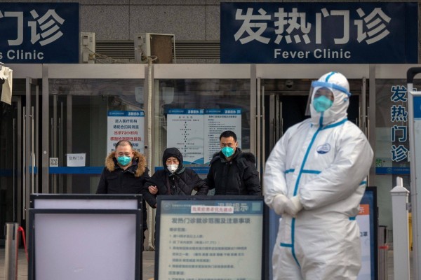 A worker in protective gear stands at the fever clinic at a hospital in Beijing on Wednesday. Photo: Bloomberg