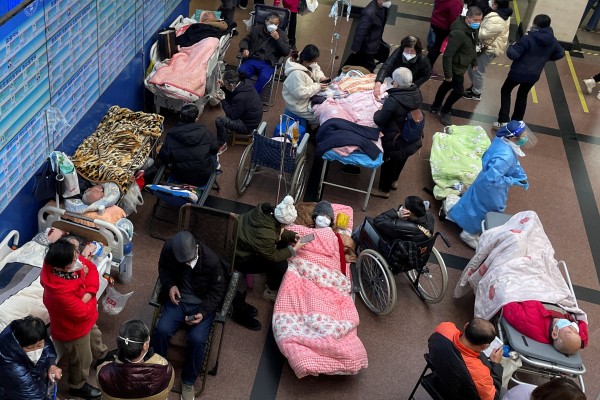 Patients lie on beds and stretchers in a hallway of a hospital’s emergency department in Shanghai on Wednesday. Photo: Reuters