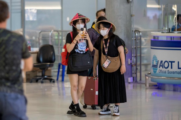 Passengers arrive at Suvarnabhumi Airport in Bangkok on Friday. Photo: AFP