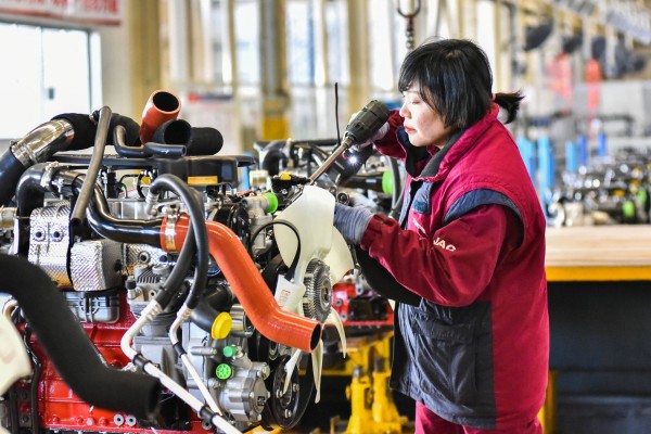 A woman works on a vehicle assembly line at a JAC Automotive factory in Qingzhou, in eastern Shandong province, on January 31. China’s economic growth could be an important factor in averting a global recession in 2023. Photo: AFP