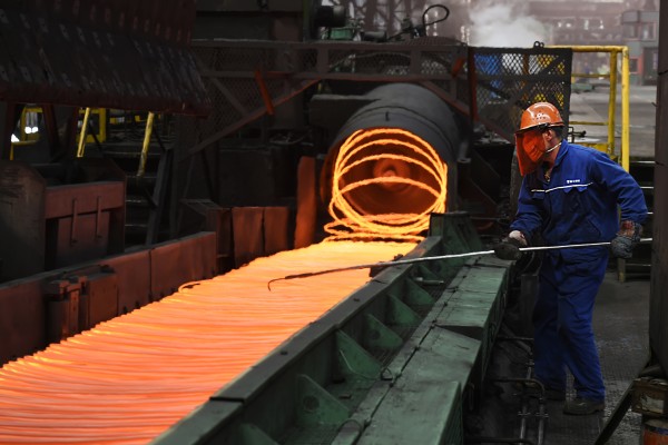 A worker manipulates coils of steel at Xiwang Special Steel in Zouping County in eastern China’s Shandong province. Photo: AP 