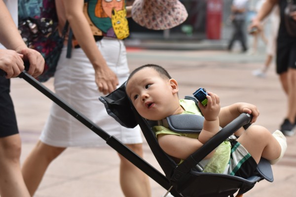 A parent pushes a child in a pram in Beijing on July 21, 2021. Photo: Getty Images
