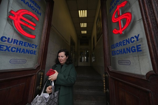 A woman leaves a currency exchange office in St Petersburg, Russia, on May 23. Denying ordinary people access to international financial services has had a serious impact on their livelihoods. Photo: AP
