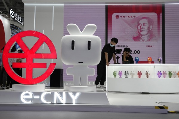 Workers man a booth promoting the digital version of the Chinese yuan in Beijing, Sept. 2, 2022. Photo: AP