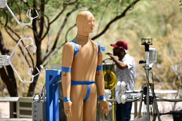 Researchers monitor an experiment with Andi, a robot developed by Arizona State University in the US, during a record heat wave in Phoenix, Arizona, on July 20. The robot is helping scientists understand how humans can protect themselves against extreme heat caused by climate change. Photo: AFP