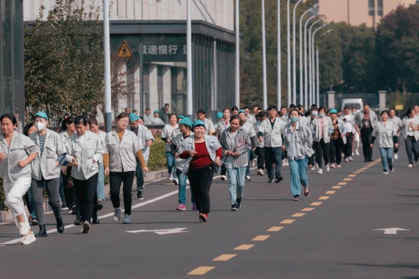 Some workers run to have lunch at the Hualida clothing factory canteen in Changzhou, Jiangsu province, on November 14. 
Retirement age in China is among the lowest globally – 60 for men, 55 for white-collar women. But with better nutrition and healthcare, workers in this cohort are retiring with longer, healthier lives ahead of them. Photo: EPA-EFE 