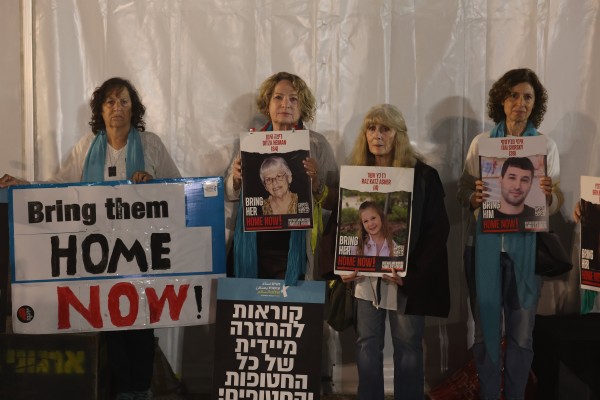 Women hold photos of people abducted by Hamas militants outside the Tel Aviv museum on Wednesday. Photo: EPA-EFE