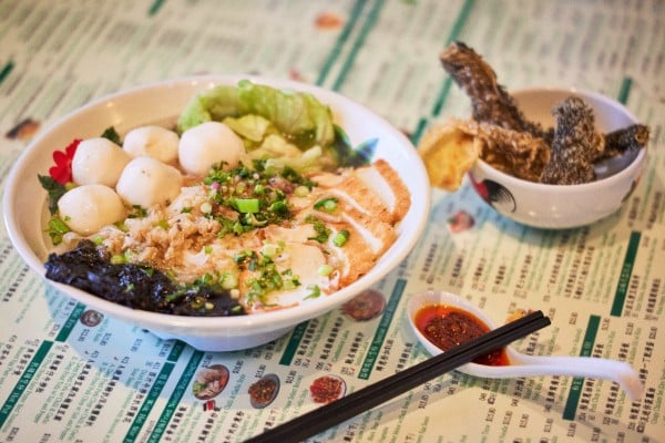 A fully loaded bowl of fish ball noodles is one of many classic Hong Kong dishes on the menu a Hong Kong Bing Sutt in Burwood, Sydney which offers milk tea, pineapple buns, and fish ball noodles to Sydneysiders and homesick Hongkongers living in Australia. Photo: Hong Kong Bing Sutt