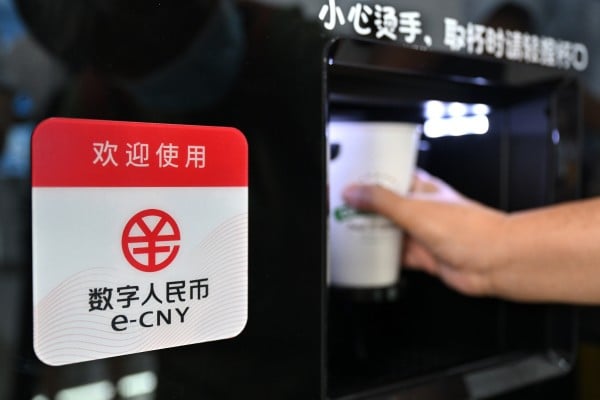 A visitor buys a cup of coffee with e-CNY at a trade fair in Beijing. Photo: Xinhua