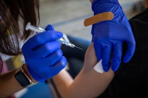 A patient gets a jab during a flu and Covid-19 vaccination clinic in Pasadena, California, in October. Photo: TNS