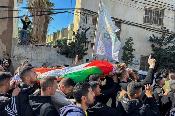 Palestinian mourners carry the body of 38-year-old Ahmad Assi, who was killed in a settler raid in the Israeli-occupied West Bank in December. Photo: Reuters