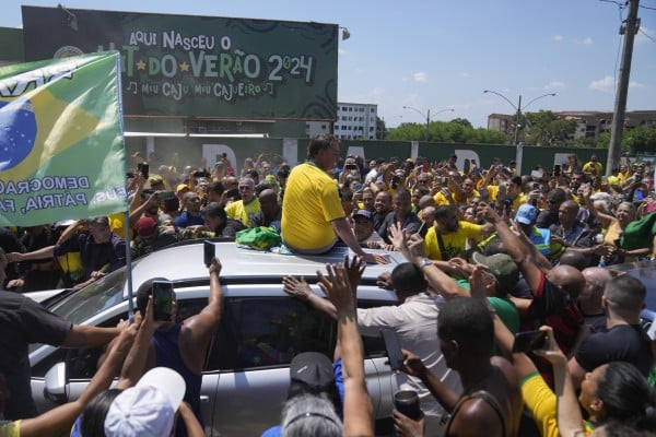 Brazil’s former president Jair Bolsonaro greets supporters after attending a campaign event launching the pre-candidacy of a mayoral candidate, in Rio de Janeiro. Photo: AP