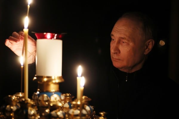 Russian President Vladimir Putin lights a candle to commemorate the victims of a terrorist attack on the Crocus City Hall concert venue, on a day of national mourning in Moscow on March 24. Photo: EPA-EFE / Kremlin Pool