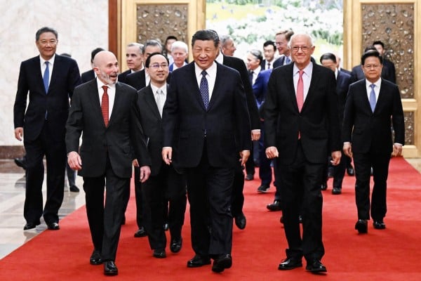 Chinese President Xi Jinping, centre, walks with representatives from US business, strategic and academic communities at the Great Hall of the People in Beijing on March 27. Xi promised the delegation more policy support to improve the business environment. Photo: Xinhua via AP