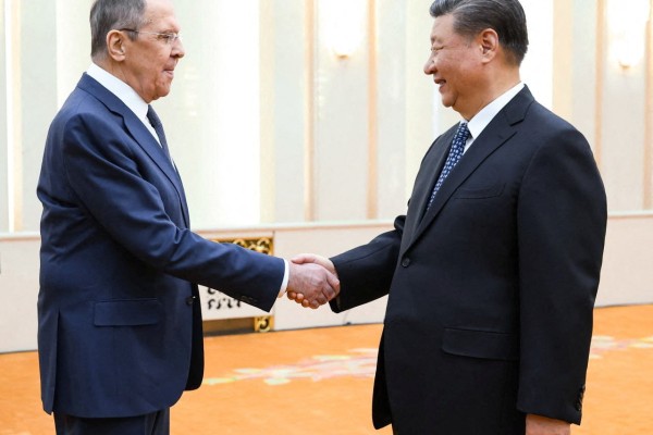 Russian Foreign Minister Sergei Lavrov greets with Chinese leader Xi Jinping in Beijing on Tuesday. Photo: Russian Foreign Ministry/Handout via Reuters