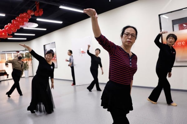 Retired kindergarten teacher Ma Qiuhua, 67, takes part in a dance class with other elderly women at Mama Sunset, a learning centre for middle-aged and senior people in Beijing, on January 15. Chinese policymakers have the difficult task of trying to improve the social safety net at a time when economic growth is slowing. Photo: Reuters