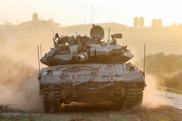 An Israeli military tank rolls near the border with the Gaza Strip, as mediators try to come to a resolution for a truce in the conflict. Photo: AFP