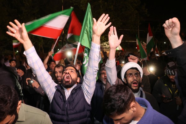 Iranian demonstrators react after the IRGC attack on Israel, during an anti-Israeli gathering in front of the British Embassy in Tehran on Sunday. Photo: WANA/Reuters