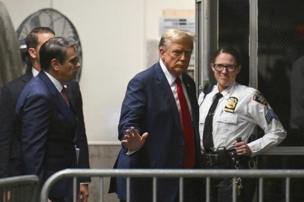 Donald Trump returns to the courtroom after a break during the first day of his trial. Photo: Pool via AP