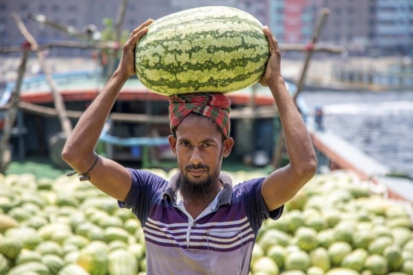 A Bangladeshi labourer unloads watermelons from a boat on the Buriganga River in Dhaka, Bangladesh, on April 3. In today’s online world, digital literacy equates to power - the power to run businesses, send money abroad and receive public services. Yet developing digital literacy skills, especially for those in rural areas, can be difficult. Photo: EPA-EFE