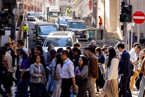 Pedestrians cross a road in Central district in Hong Kong in 2023. Government statistics registered a net inflow of people in the last two years. Photo: Bloomberg