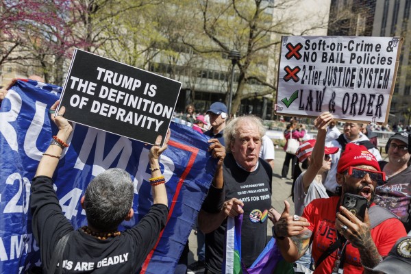 Trump and anti-Trump supporters clash outside a criminal court in New York where the former president was set to attend the first day of his hush money trial on April 15. Photo: EPA-EFE