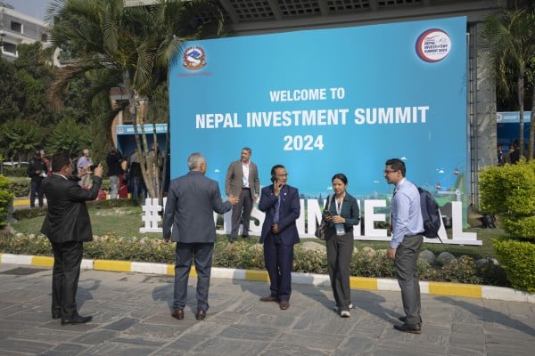 Participants of Nepal Investment Summit take photos during the first day of the event in Kathmandu. Photo: AP