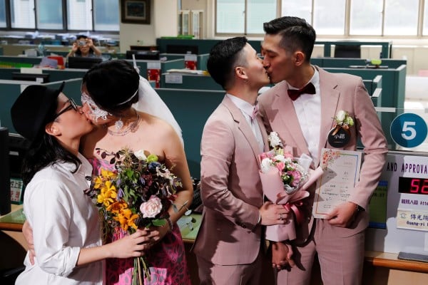 Couples Shane Lin (right) and Marc Yuan, and Cynical Chick (left) and Li Ying-Chien, kiss after registering for marriage at the Household Registration Office in Taipei, Taiwan on May 24, 2019. Photo: Reuters Couples Shane Lin (right) and Marc Yuan, and Cynical Chick (left) and Li Ying-Chien, kiss after registering for marriage at the Household Registration Office in Taipei, Taiwan on May 24, 2019. Photo: Reuters