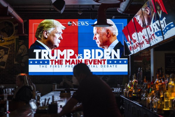 Television screens airing a presidential debate Donald Trump and Joe Biden. Photo: Getty Images