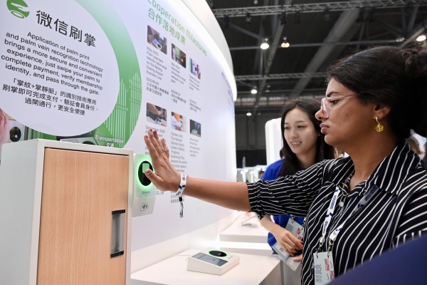 Trying out Weixin’s Palm Scan Payments at Hong Kong FinTech Week. Photo: China News Service/VCG via Getty Images 