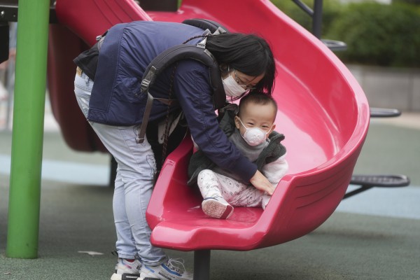 A woman and a child wear masks at a playground. Since the start of the flu season in January, the city has recorded 240 severe cases, with 90 per cent of the adult ones involving people aged 65 and above. Photo: Sam Tsang