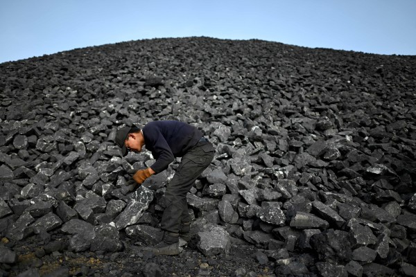 A worker sorts coal near a mine in northern China’s Shanxi province. Photo: AFP