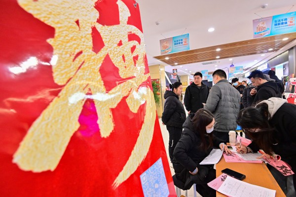 A job-seeker fills in her personal information during a job fair in Qingzhou, Shandong province, last month. Photo: Xinhua