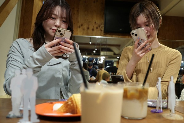 Momoka Matsui and her co-worker Saki Matsumoto at After All Coffee in Tokyo, where Matsui’s favourite boy band stopped by. They are taking part in “oshikatsu”, a fan-driven phenomenon in Japan that is boosting consumer spending. Photo: Reuters
