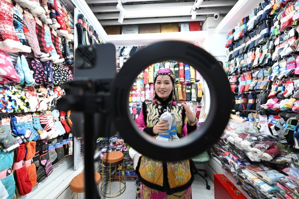 The owner of a sock shop in Yiwu International Trade City uses AI to generate a product introduction video in English on February 25 in Yiwu, Zhejiang province. Photo: China News Service via Getty Images 