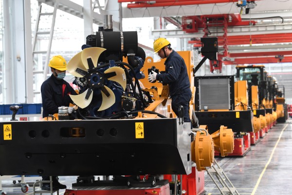 Employees work on the assembly line inside a Sany factory in Zhejiang province in April 2023. Photo: Getty Images