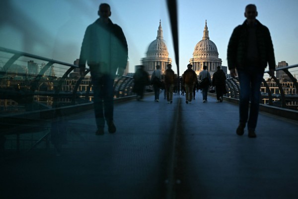 People on the Millennium Bridge in London, with St Paul’s Cathedral in the background. The UK government said on Monday it would be adopting a tougher stance on immigration. Photo: AFP