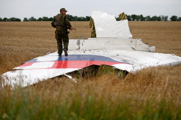 An armed pro-Russian separatist stands on part of the wreckage of Malaysia Airlines Flight MH17 after it crashed near the settlement of Grabovo in the Donetsk region of Ukraine on July 17, 2014. Photo: Reuters