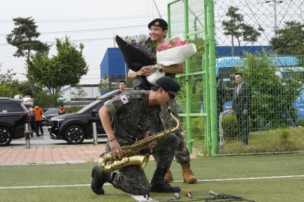 RM plays the saxophone alongside his bandmate V while meeting fans in Chuncheon. Photo: AP