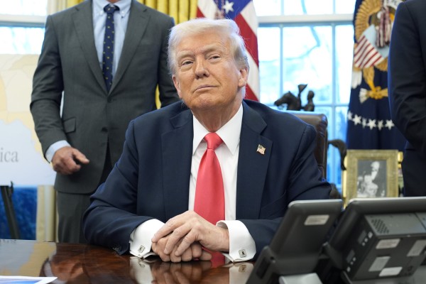 US President Donald Trump speaks to reporters after signing executive orders in the Oval Office of the White House in Washington on February 25. Photo: TNS