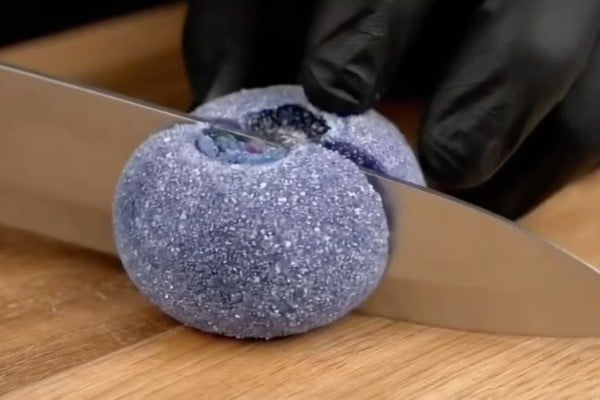 A still from an AI ASMR video showing someone slicing sugared blueberries. The video, which also shows other fruit being cut up, was posted in July by RedNote user Yu Mu and has received more than 7,000 likes. Photo: Rednote/ Healing Lab A still from an AI ASMR video showing someone slicing sugared blueberries. The video, which also shows other fruit being cut up, was posted in July by RedNote user Yu Mu and has received more than 7,000 likes. Photo: Rednote/ Healing Lab