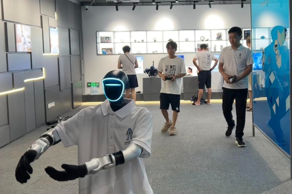 Deputy manager Zhang Shuai puts a humanoid robot through its paces with a tai chi demonstration at the Future Era store in Shenzhen on Wednesday. Photo: Alice Li