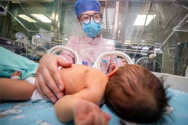 A nurse takes care of a newborn baby at a hospital in Taizhou, in China’s eastern Jiangsu province, on May 12, 2023. Photo: AFP