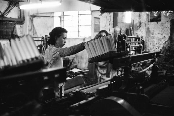 A worker at the loom of a one-room factory in the basement of a tenement building in Hong Kong during the 1960s. Photo: Getty Images A worker at the loom of a one-room factory in the basement of a tenement building in Hong Kong during the 1960s. Photo: Getty Images
