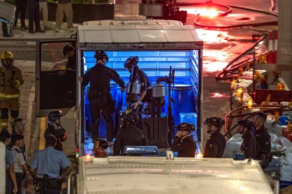 Officers from the bomb disposal team get their gear ready on Pan Hoi Street. Photo: Robert Ng Officers from the bomb disposal team get their gear ready on Pan Hoi Street. Photo: Robert Ng