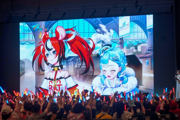 Fans wave glowsticks at a screen featuring VTubers Hakos Baelz (left) and Kobo Kanaeru at the Hopewell Hotel Grand Ballroom in Hong Kong, part of the “hololive Meet @ Hong Kong 2025 ft. Hakos Baelz and Kobo Kanaeru” event, on July 27, 2025. Photo: Cover via InfiniteOne